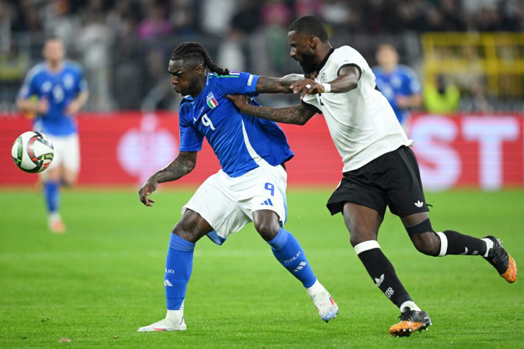 DORTMUND, GERMANY - MARCH 23: Moise Kean of Italy is challenged by Antonio Rudiger of Germany during the UEFA Nations League Quarterfinal Leg Two match between Germany and Italy at Football Stadium Dortmund on March 23, 2025 in Dortmund, Germany. (Photo by Stuart Franklin/Getty Images)