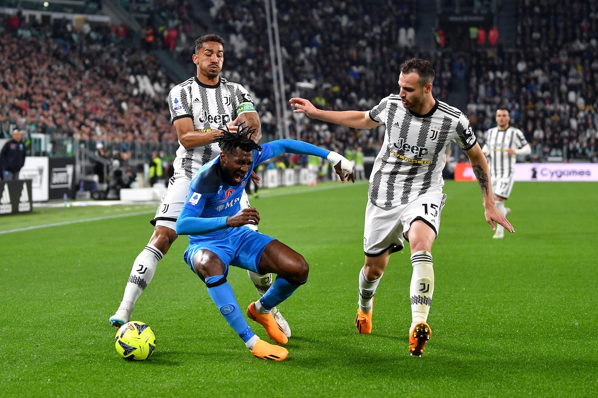 TURIN, ITALY - APRIL 23: Andre-Frank Zambo Anguissa of SSC Napoli is challenged by Danilo and Federico Gatti of Juventus during the Serie A match between Juventus and SSC Napoli at Allianz Stadium on April 23, 2023 in Turin, Italy. (Photo by Valerio Pennicino/Getty Images)