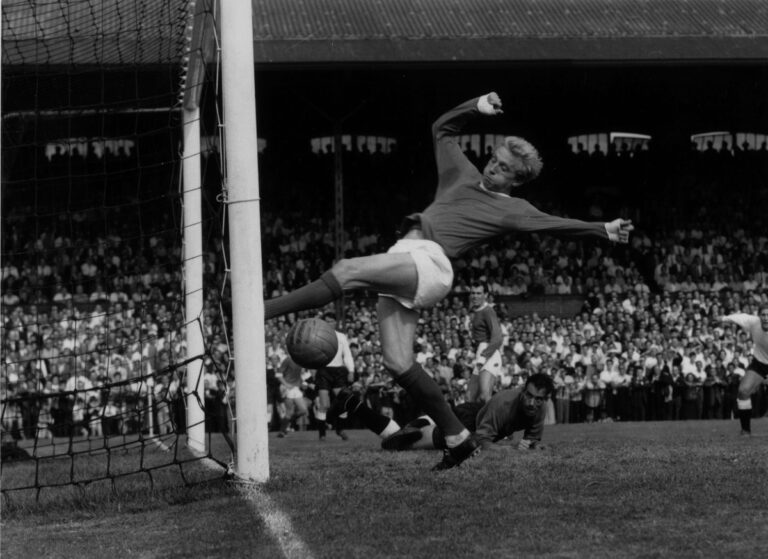 5th September 1964: Scotland and Manchester United footballer Denis Law scoring during a game against Fulham. Law was signed for Huddersfield by Bill Shankly and played at Manchester City before a season with Torino. He moved back to England to play for Manchester United where he won two League Championship medals before returning to Manchester City to end his career. He now works as a sports commentator and after dinner speaker. (Photo by Kent Gavin/Keystone/Getty Images)