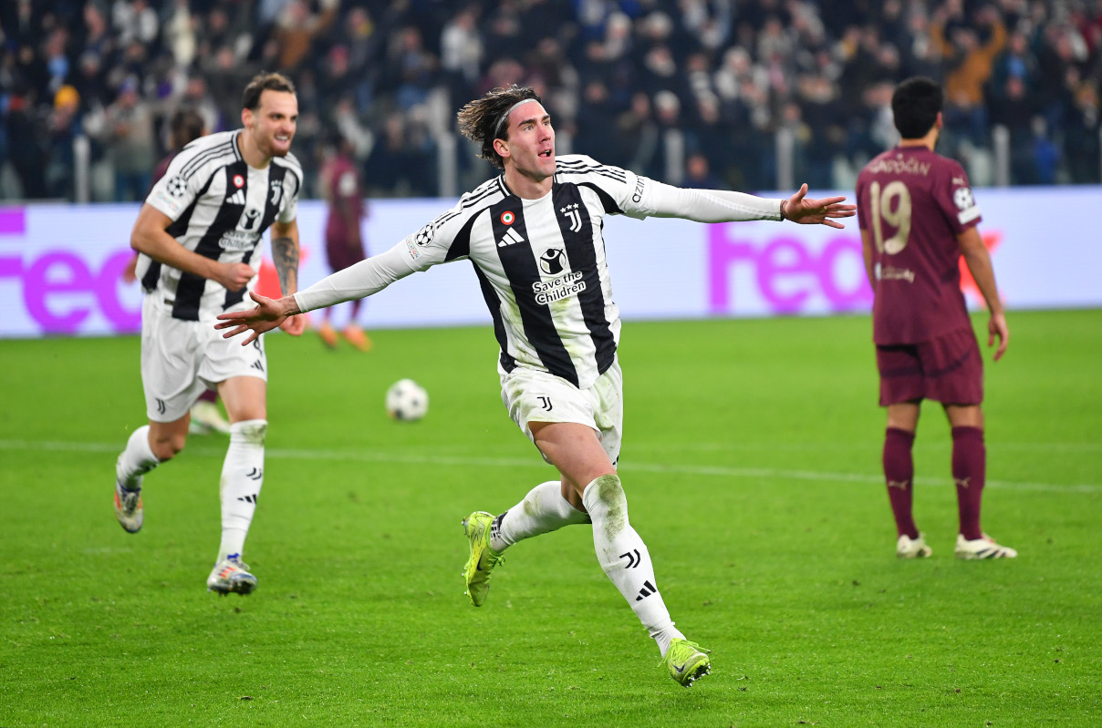 TURIN, ITALY - DECEMBER 11: Dusan Vlahovic of Juventus celebrates scoring his team's first goal during the UEFA Champions League 2024/25 League Phase MD6 match between Juventus and Manchester City at Juventus Stadium on December 11, 2024 in Turin, Italy. (Photo by Valerio Pennicino/Getty Images)