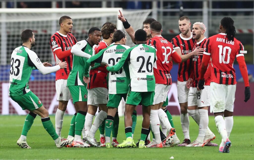 MILAN, ITALY - FEBRUARY 18: Theo Hernandez #19 of AC Milan clashes with Anis Hadj Moussa of Feyenoord during the UEFA Champions League 2024/25 League Knockout Play-off second leg match between AC Milan and Feyenoord at Stadio Giuseppe Meazza on February 18, 2025 in Milan, Italy. (Photo by Marco Luzzani/Getty Images)