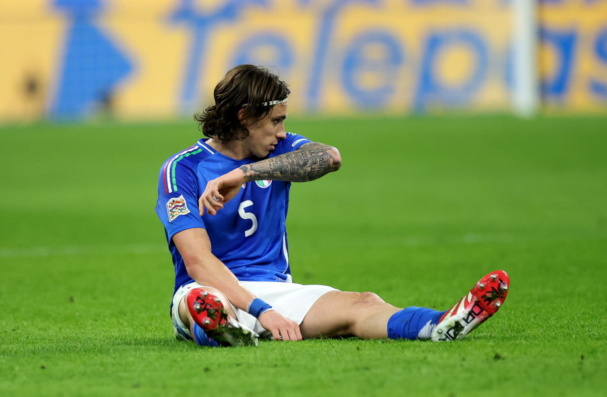 MILAN, ITALY - MARCH 20: Riccardo Calafiori of Italy goes down with an injury during the UEFA Nations League quarterfinal leg one match between Italy and Germany at Stadio San Siro on March 20, 2025 in Milan, Italy. (Photo by Alex Grimm/Getty Images)