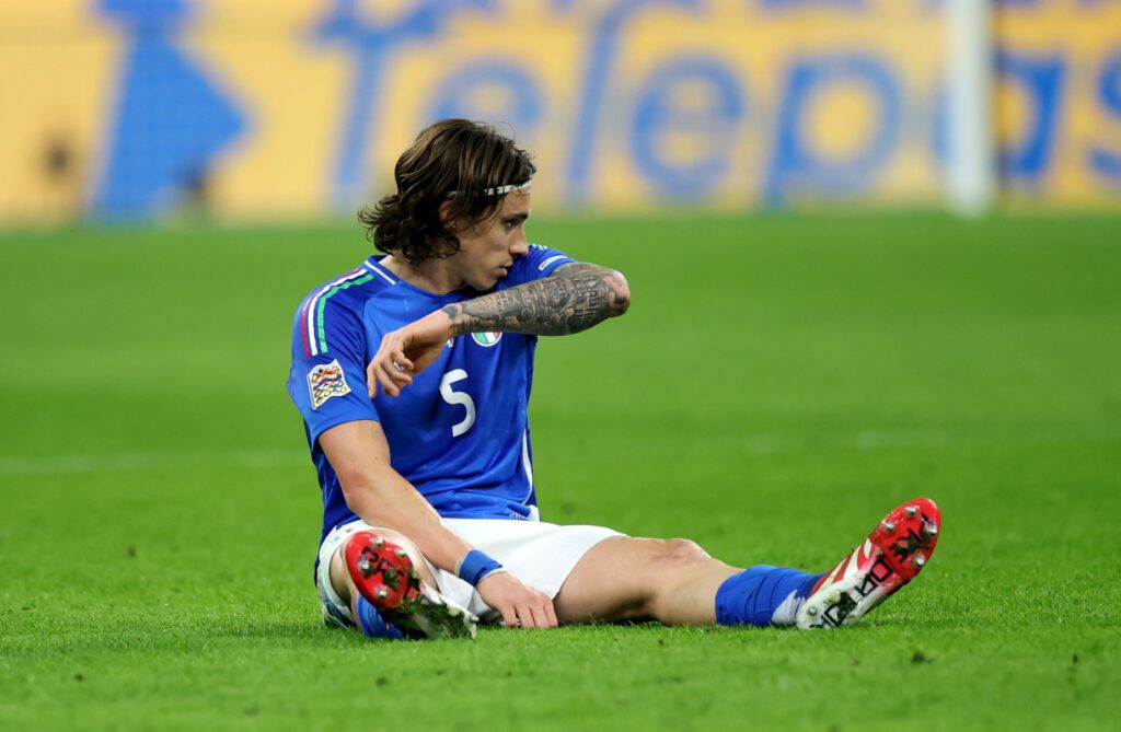 MILAN, ITALY - MARCH 20: Riccardo Calafiori of Italy goes down with an injury during the UEFA Nations League quarterfinal leg one match between Italy and Germany at Stadio San Siro on March 20, 2025 in Milan, Italy. (Photo by Alex Grimm/Getty Images)