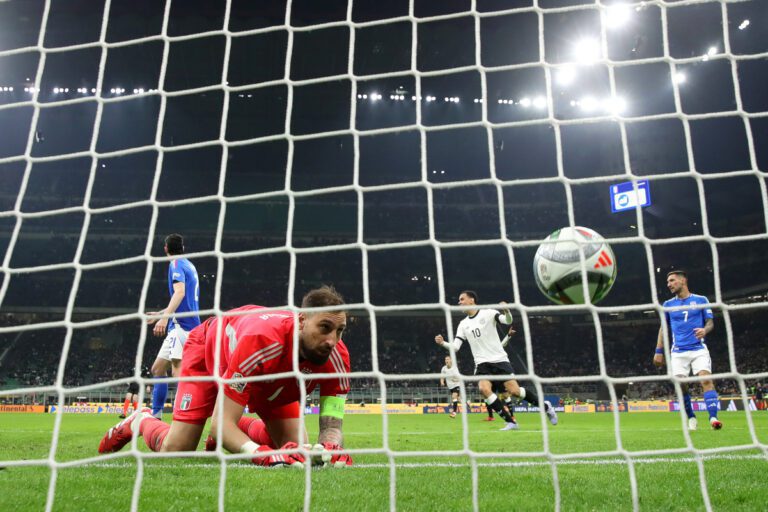 MILAN, ITALY - MARCH 20: Gianluigi Donnarumma of Italy reacts after Tim Kleindienst of Germany (not pictured) scores his team's first goal during the UEFA Nations League quarterfinal leg one match between Italy and Germany at Stadio San Siro on March 20, 2025 in Milan, Italy. (Photo by Alex Grimm/Getty Images)