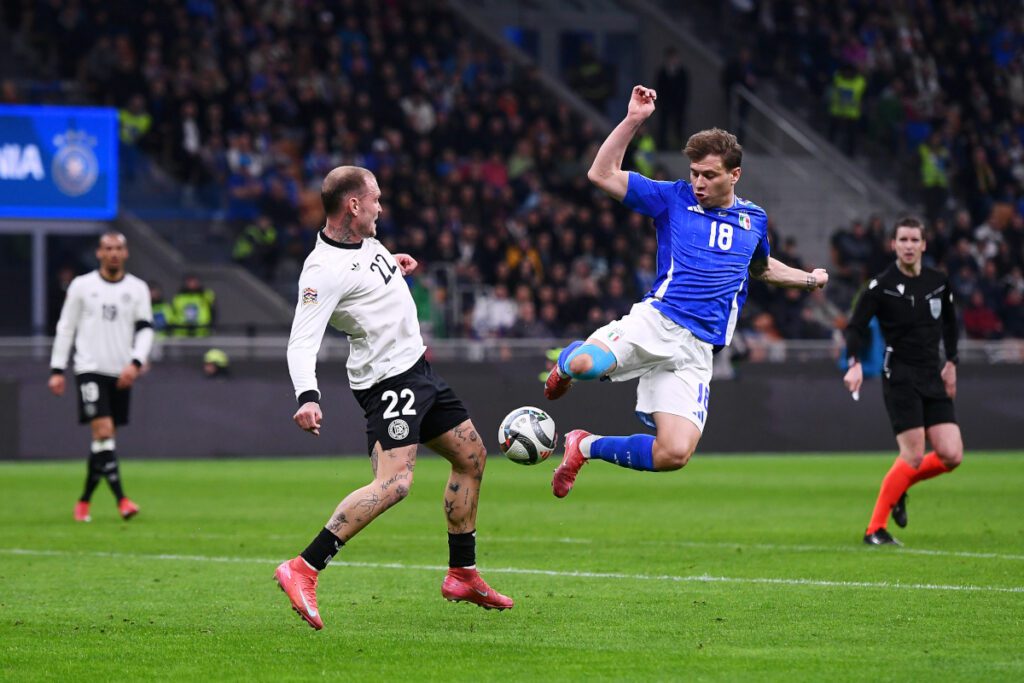 MILAN, ITALY - MARCH 20: David Raum of Germany and Nicolo Barella of Italy battle for possession during the UEFA Nations League quarterfinal leg one match between Italy and Germany at Stadio San Siro on March 20, 2025 in Milan, Italy. (Photo by Alessandro Sabattini/Getty Images)
