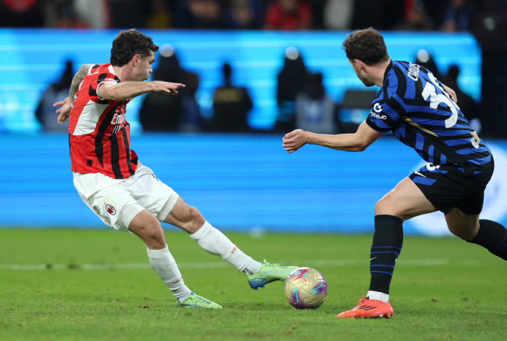 RIYADH, SAUDI ARABIA - JANUARY 06: Christian Pulisic of AC Milan scores his team's second goal under pressure from Carlos Augusto of FC Internazionale during the Italian Super Cup Final between FC Internazionale and AC Milan at Kingdom Arena on January 06, 2025 in Riyadh, Saudi Arabia. (Photo by Yasser Bakhsh/Getty Images)