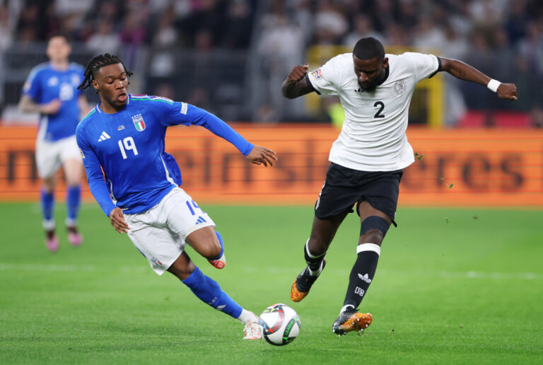 DORTMUND, GERMANY - MARCH 23: Destiny Udogie of Italy battles for possession with Antonio Ruediger of Germany during the UEFA Nations League Quarterfinal Leg Two match between Germany and Italy at Football Stadium Dortmund on March 23, 2025 in Dortmund, Germany. (Photo by Dean Mouhtaropoulos/Getty Images)