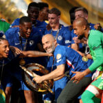 EAST RUTHERFORD, NEW JERSEY - JULY 13: Enzo Maresca, Head Coach of Chelsea FC, celebrates with the FIFA Club World Cup trophy after their team