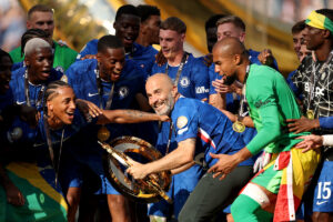 EAST RUTHERFORD, NEW JERSEY - JULY 13: Enzo Maresca, Head Coach of Chelsea FC, celebrates with the FIFA Club World Cup trophy after their team