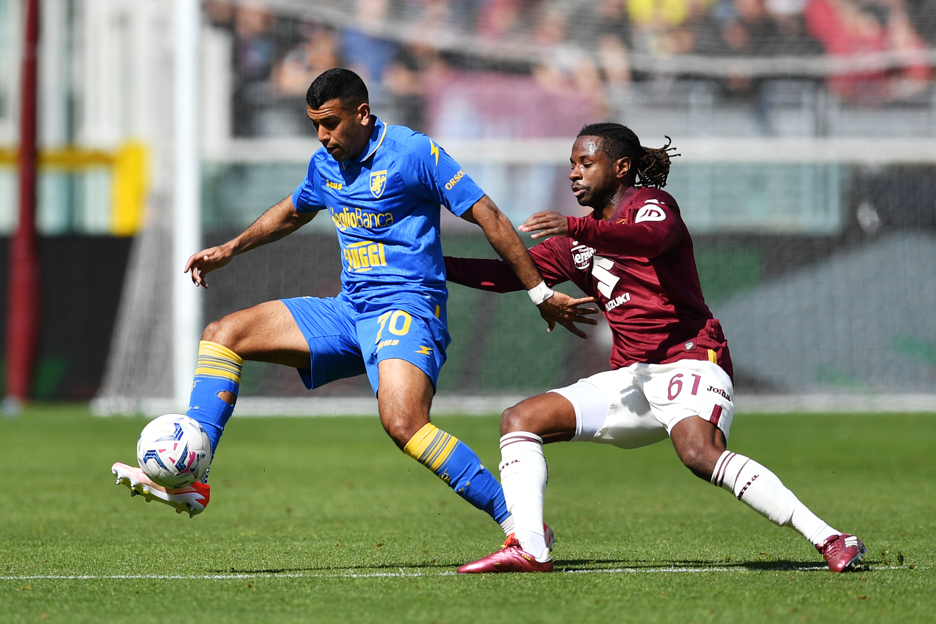 TURIN, ITALY - APRIL 21: Walid Cheddira of Frosinone Calcio is challenged by Adrien Tameze of Torino FC during the Serie A TIM match between Torino FC and Frosinone Calcio at Stadio Olimpico di Torino on April 21, 2024 in Turin, Italy. (Photo by Valerio Pennicino/Getty Images)