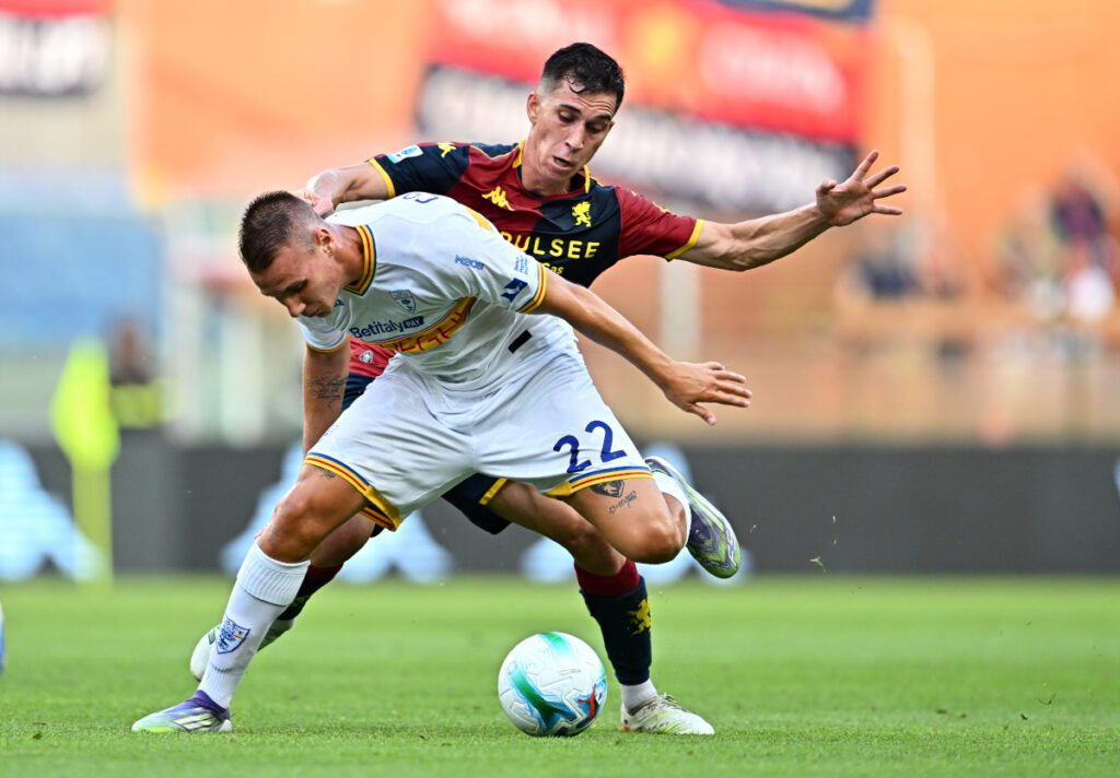 GENOA, ITALY - AUGUST 23: Francesco Camarda of Lecce is challenged by Patrizio Masini of Genoa during the Serie A match between Genoa CFC and US Lecce at Luigi Ferraris Stadium on August 23, 2025 in Genoa, Italy. (Photo by Simone Arveda/Getty Images)