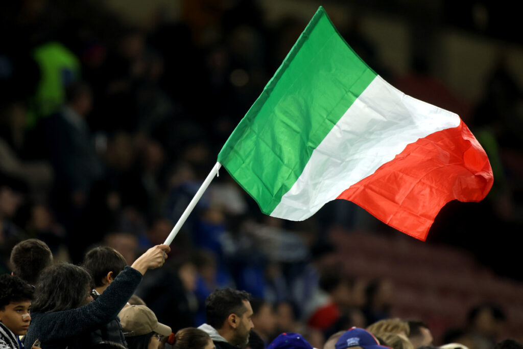 MILAN, ITALY - MARCH 20: An Italy flag is waved by a fan prior to the UEFA Nations League quarterfinal leg one match between Italy and Germany at Stadio San Siro on March 20, 2025 in Milan, Italy. (Photo by Alex Grimm/Getty Images)