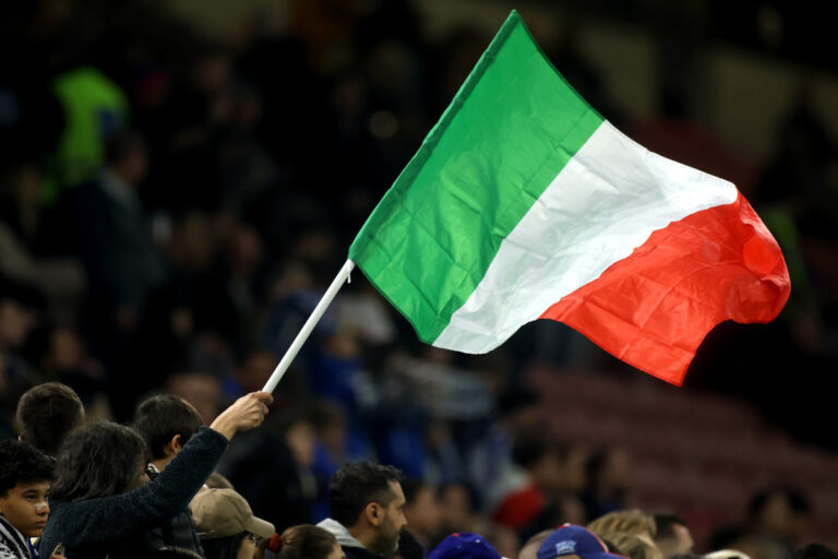 MILAN, ITALY - MARCH 20: An Italy flag is waved by a fan prior to the UEFA Nations League quarterfinal leg one match between Italy and Germany at Stadio San Siro on March 20, 2025 in Milan, Italy. (Photo by Alex Grimm/Getty Images)